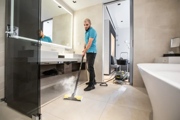 Steam cleaner in use in a bathroom